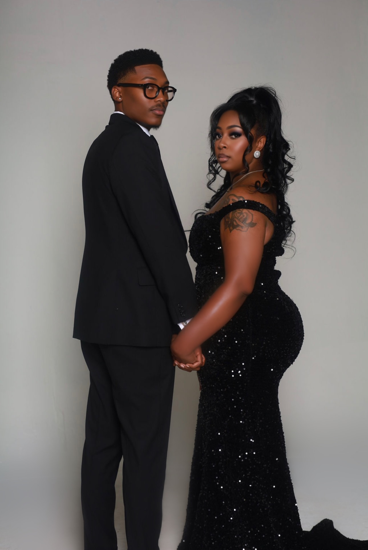 Samaria and Michael dressed elegantly in black, holding hands